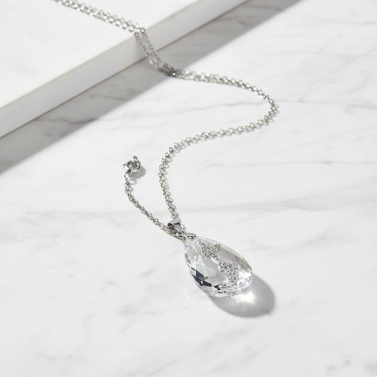Simple Drop Pendant Necklace flat lay on white marble