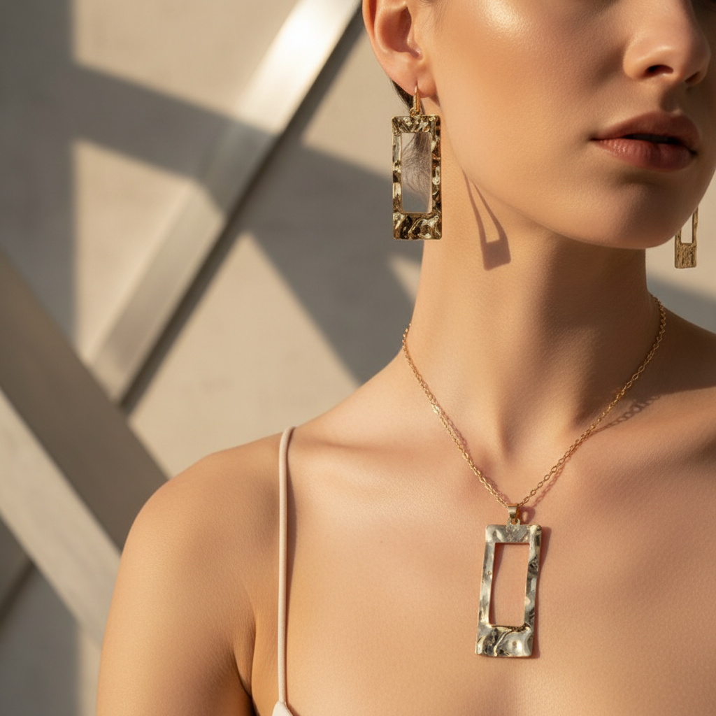 Close-up of Hammered Geometric gold necklace and earring on Caucasian model