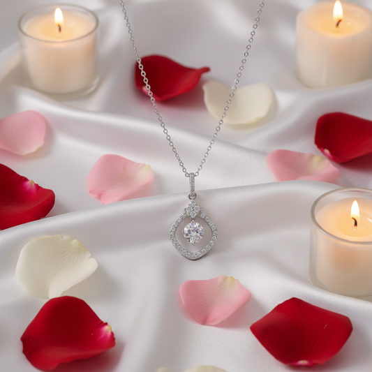 Starlight Heart Moissanite Necklace flat lay on white satin with rose petals