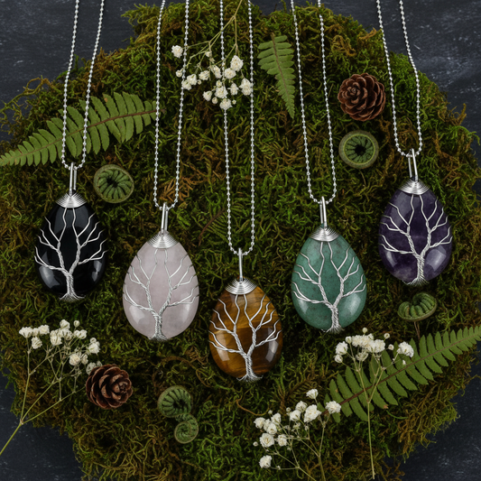 Celtic Tree of Life Necklace all five stone variants flat lay on dark moss