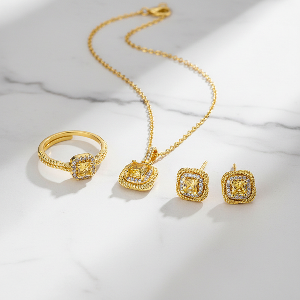 Sugar Cube gold jewelry set flat lay on white marble