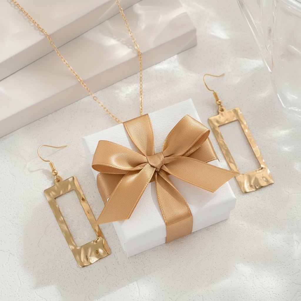 Hammered Geometric Jewellery Set flat lay on white marble next to luxury gift box