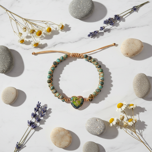 Natural Stone Love Bracelet flat lay on white marble with pebbles and wildflowers