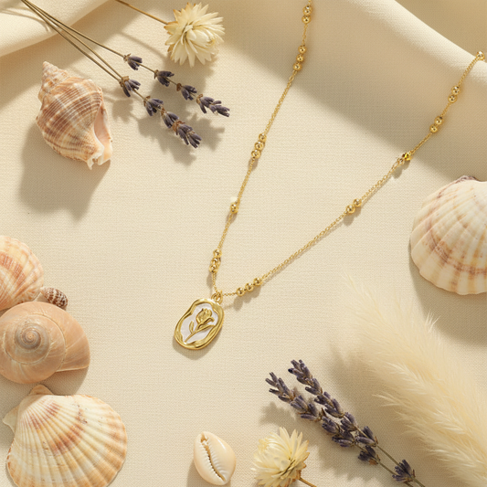 Rose Shell mother of pearl necklace flat lay with seashells and flowers